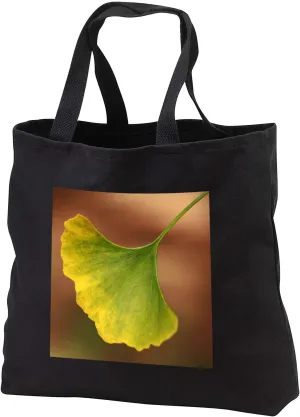 3dRose Macro photograph of a single ginkgo biloba leaf changing for autumn. - Tote Bags (tb_341074)